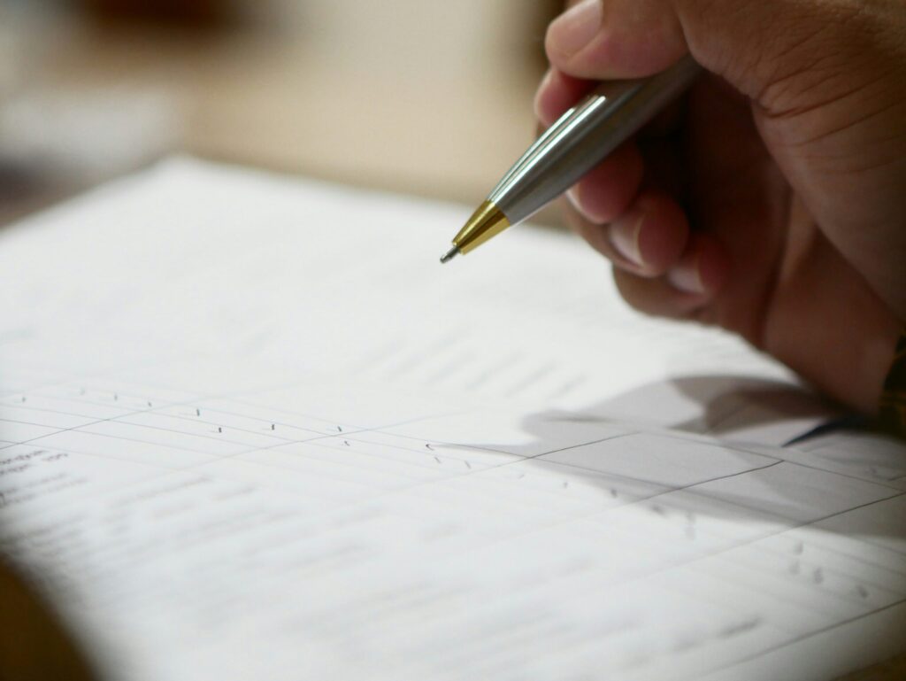 Business professional reviewing supplier documentation as part of a UK vendor due diligence process.